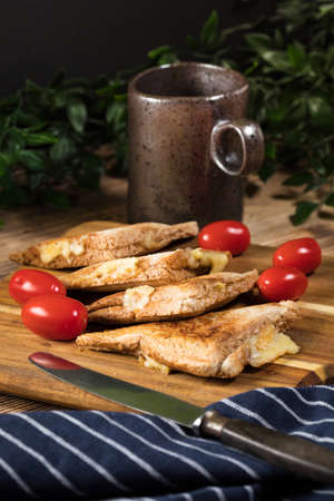 Grilled cheese sandwich on a chopping board. Shallow depth of field.