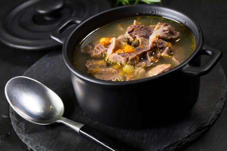 Chicken gizzards stewed with carrot in sauce. Shallow depth of field.の写真素材