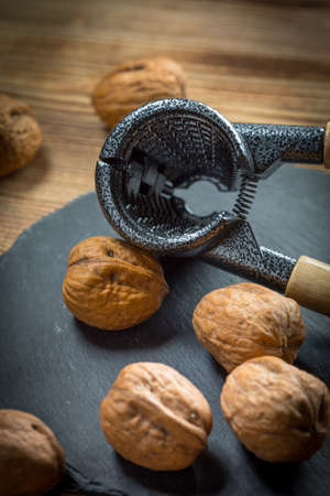 Whole nuts and nutcracker.  Shallow depth of field.の写真素材