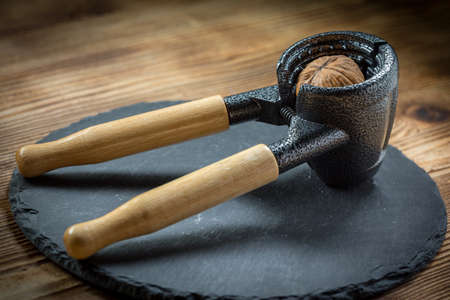 Whole nuts and nutcracker.  Shallow depth of field.の写真素材