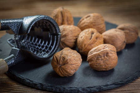 Whole nuts and nutcracker.  Shallow depth of field.