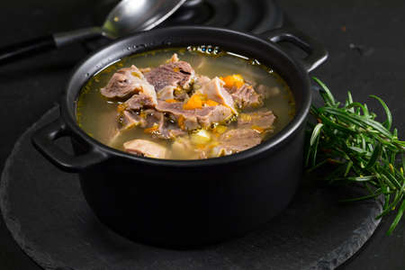 Chicken gizzards stewed with carrot in sauce. Shallow depth of field.の写真素材
