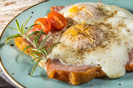 Fried eggs with pork ham on wooden table.の写真素材