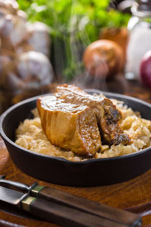 Traditional spare ribs baked in sauerkraut. Selective focus.