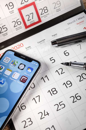KATOWICE, POLAND - February 23, 2020 : smartphone iPhone XS from Apple and calendar on 2020 year.のeditorial素材