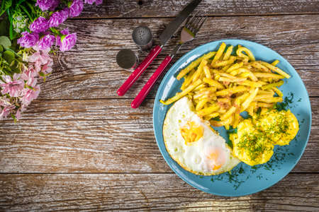 Fried egg served with boiled potatoes and yellow beans. Selective focus.の写真素材