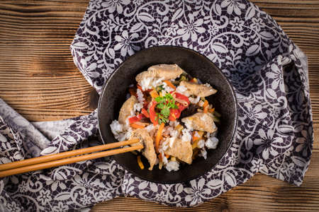 Fried chicken with rice and vegetables in bowl. Top view.の写真素材