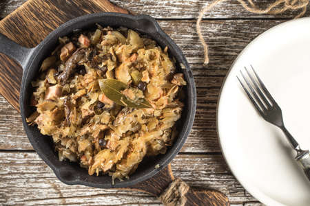 Bigos, a traditional Polish dish of sauerkraut served in a cast iron skillet.