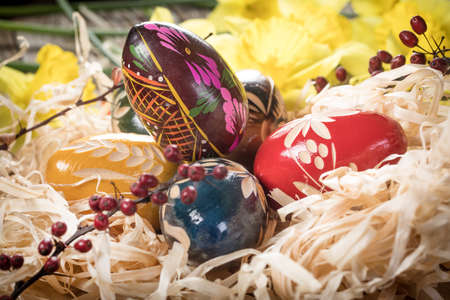 Decorated eggs on a wooden board. Shallow depth of field.の写真素材