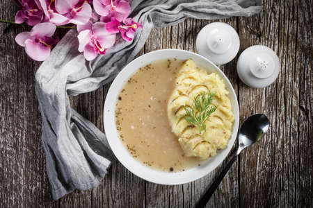Pure white borscht served with mashed potatoes. Top view.の写真素材
