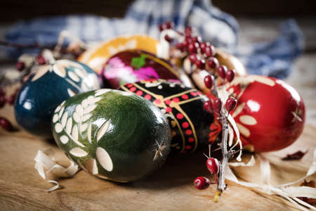 Decorated eggs on a wooden board. Shallow depth of field.