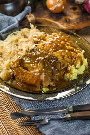 Fried ribs in sauerkraut served with boiled potatoes.  Selective focus.