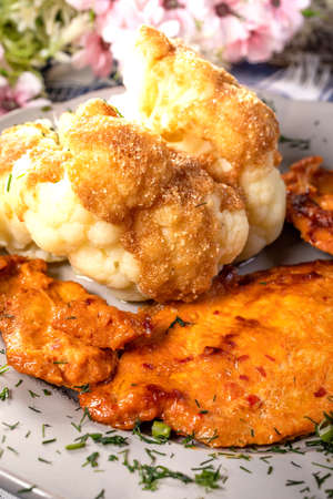 Marinated chicken breast served with boiled cauliflower.の写真素材