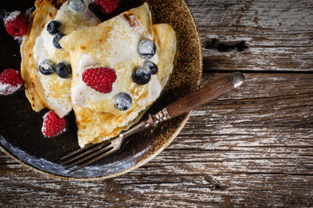 Homemade pancakes with white cheese and fruit.の写真素材