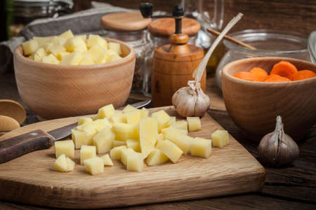 Sliced ingredients prepared to cook a tasty potato soup.の写真素材