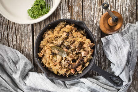 Bigos, a traditional Polish dish of sauerkraut served in a cast iron skillet.