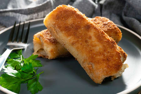 Croquettes with mushrooms and sauerkraut on a dark plate.の写真素材