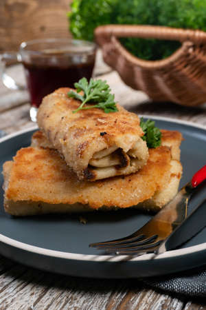 Croquettes with mushrooms and sauerkraut on a dark plate.の写真素材