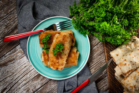 Croquettes with mushrooms and sauerkraut on a dark plate.の写真素材