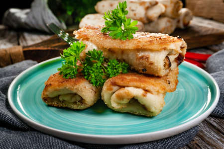 Croquettes with mushrooms and sauerkraut on a dark plate.の写真素材