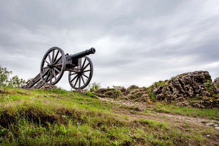 CHECINY, POLAND - SEPTEMBER 06, 2020: Historic cannon in front of Prison Tower and Eastern Gate of...
