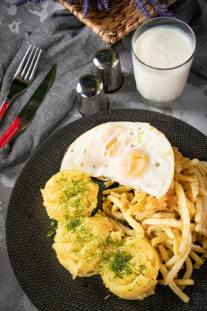 Fried eggs with boiled potatoes and yellow string beans. Tasty meal.の写真素材