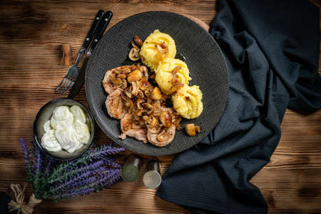 Grilled pork loin with onion and champignons, served with mashed potatoes.の写真素材