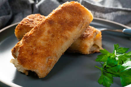 Croquettes with mushrooms and sauerkraut on a dark plate.の写真素材