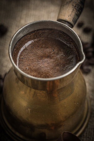 Turkish coffee in copper coffee pot on wooden background.の写真素材