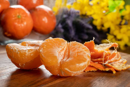 Slices of mandarin on wooden table.の写真素材