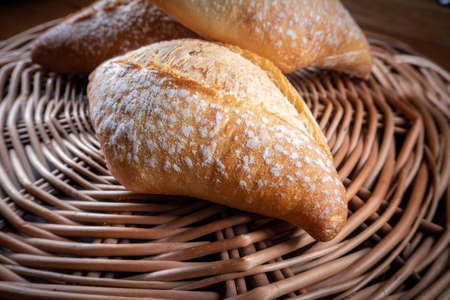 Wheat roll on a wicker pad. Shallow depth of field.の写真素材