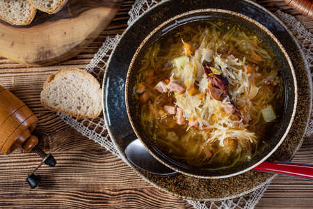 Traditional cabbage soup on wooden table.の写真素材