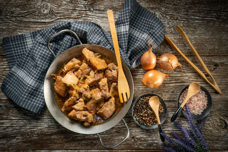 Stewed pork shoulder with onion in a pan.の写真素材