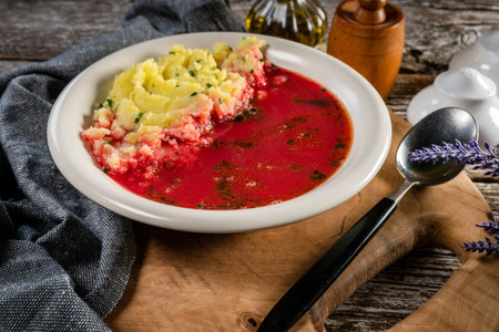 Red borscht served with mashed potatoes in a bowl.の写真素材