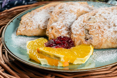 Pancakes stuffed with cheese sprinkled with powdered sugar.