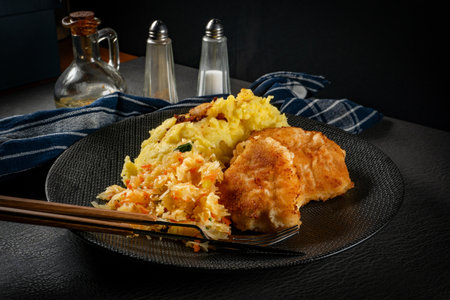 Fried cod fillet served with boiled potatoes and vegetable salad.の写真素材