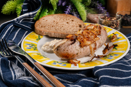 Fried white sausage with onion and grated horseradish. Small depth of field.の写真素材