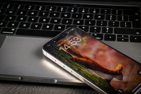 KATOWICE, POLAND - DECEMBER 16, 2023 : Modern smartphone Apple iPhone 15 Pro and Apple Macbook Pro...