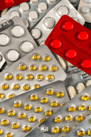 Different medicines: tablets, pills in blister pack. Shallow depth of field.