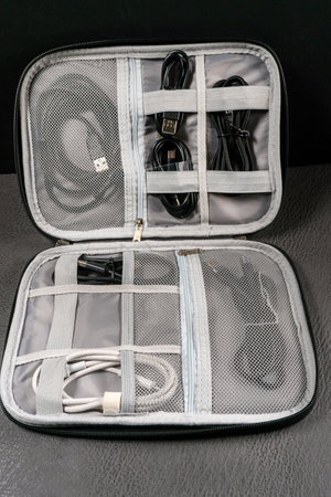 USB cables arranged in an organizer with compartments.