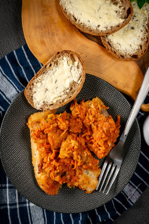 Fish in Greek kind with vegetables and tomato sauce. Shallow depth of field.