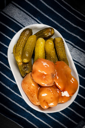 Pickled saffron mushrooms and preserved cucumbers in a bowl.の写真素材