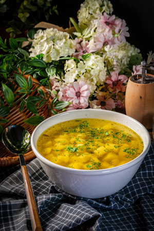 Broth - chicken soup with potatoes in a bowl.の写真素材