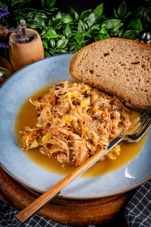 Stewed sauerkraut with smoked meat and potatoes. Shallow depth of field.の写真素材