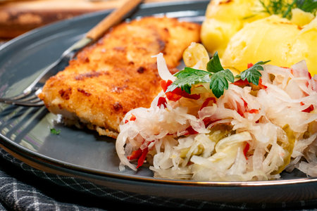 Fried pollock fillet served with boiled potatoes.