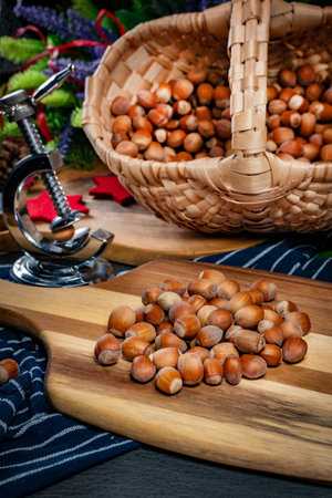 Hazelnuts on a wooden board and in a wicker basket.の写真素材