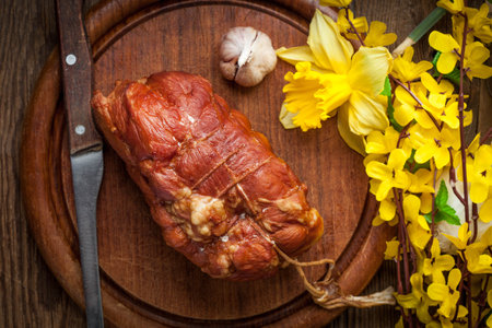 Delicious smoked ham on a wooden board. Top view.の写真素材