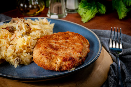 Minced meat cutlet with boiled cabbage and potatoes. Shallow depth of field.の写真素材