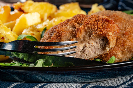 Meatballs served with boiled potatoes on a plate.