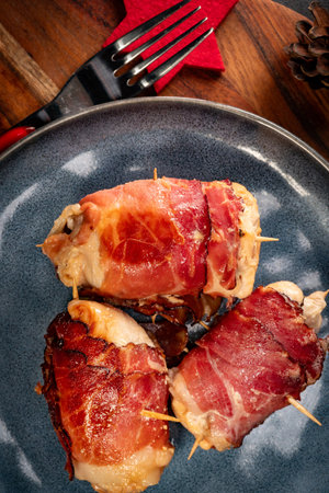 Chicken breast stuffed with champignon, onion and cheese wrapped with bacon.の写真素材